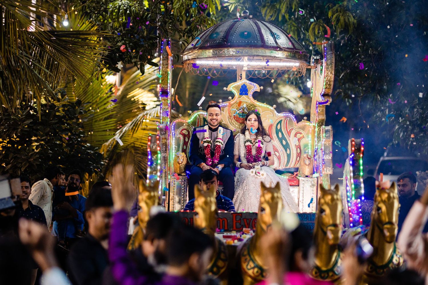 Colorful nighttime wedding celebration with vibrant lighting and decorative elements.