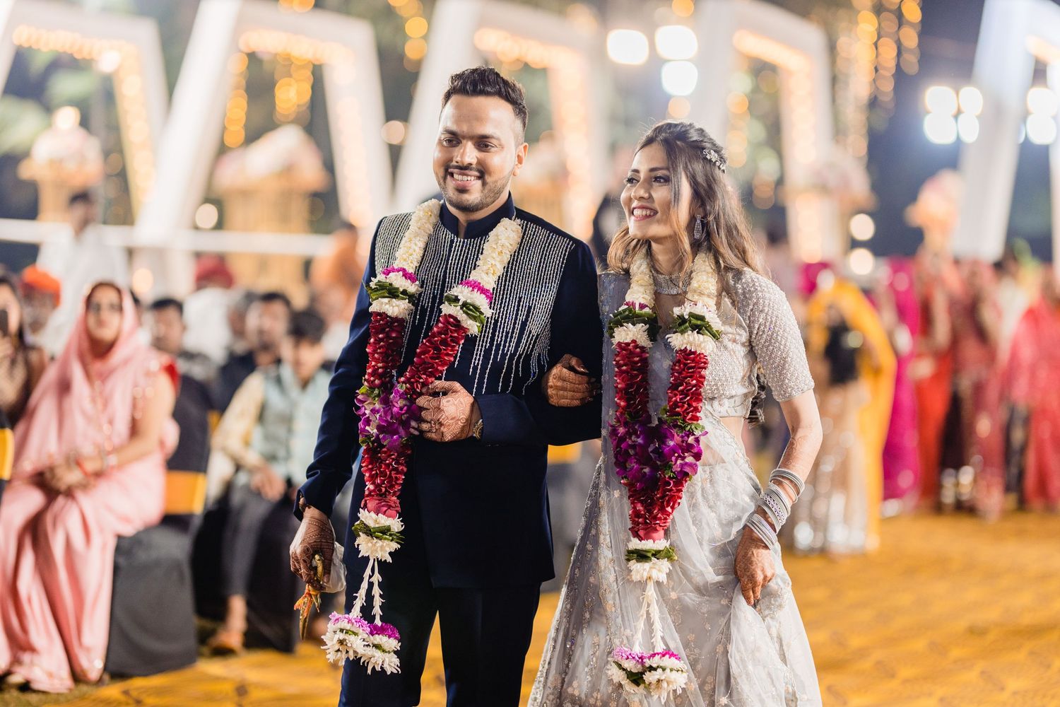 Evening wedding celebration with festive lighting and guests in formal attire.
