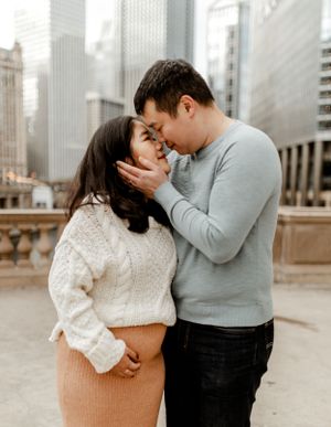 An intimate moment shared between a couple against Chicago's dramatic cityscape.