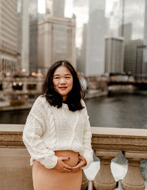 A candid portrait with the Chicago River and downtown skyline creating a stunning urban backdrop.