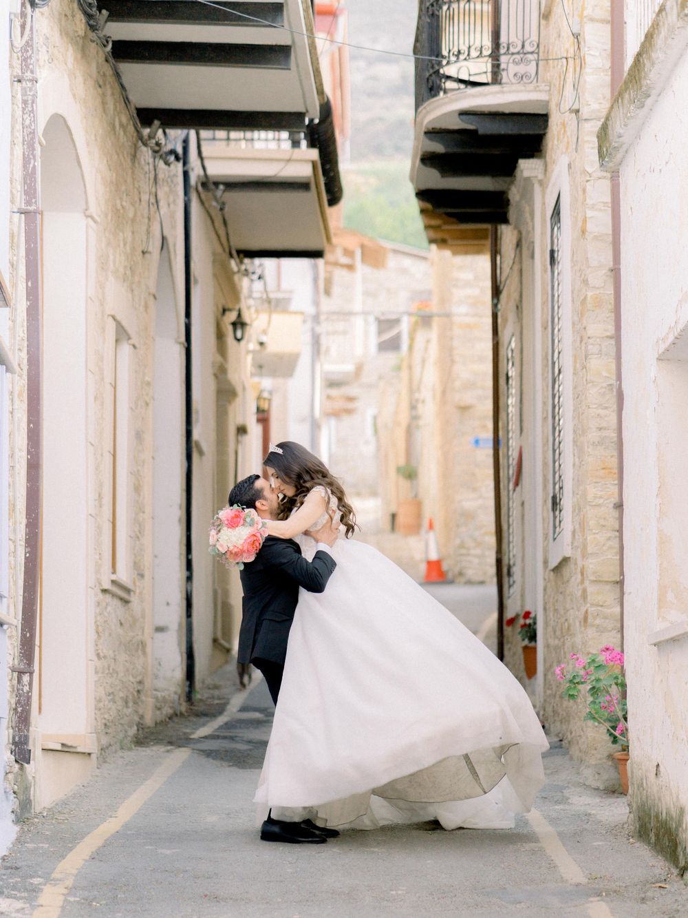 Destination wedding in Cyprus, Lefkara village. Beautiful couple kissing in the old streets