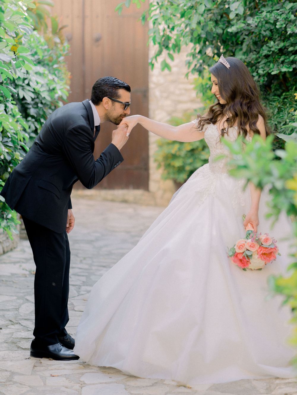 Destination wedding in Cyprus, Lefkara village. Groom kisses wife's hand