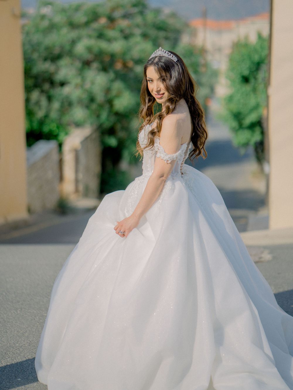 Destination wedding in Cyprus, Lefkara village. stunning bride looking behind in a stunning bridal dress
