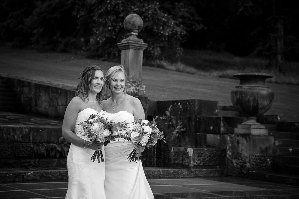 Dramatic black and white wedding portraits showcase architectural details and natural lighting.