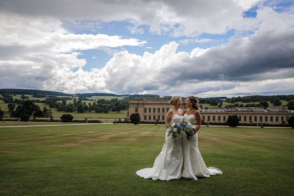 Sweeping panoramic views of a stately manor house and grounds on a cloudy day.