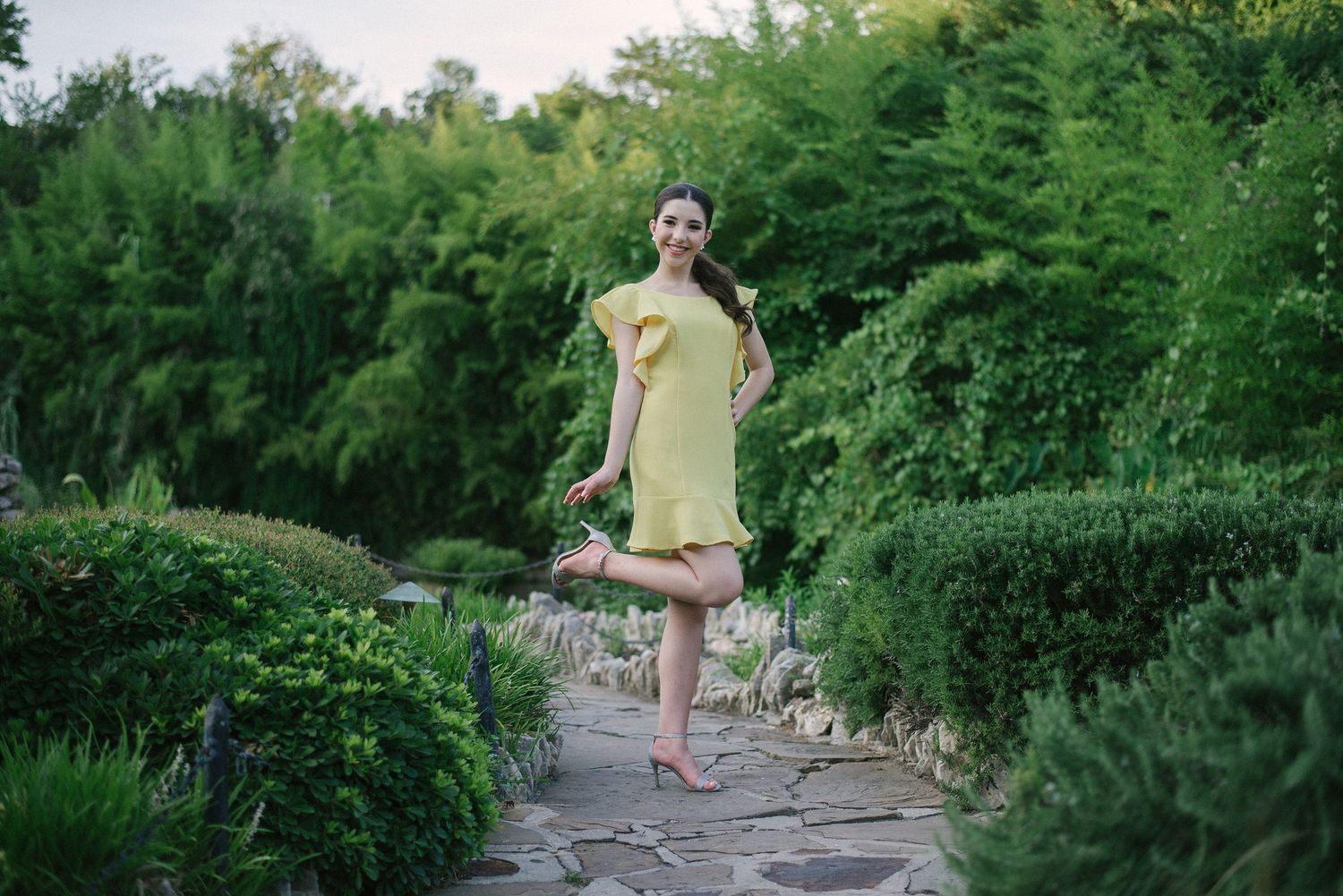 Wedding photography session in a serene garden landscape with stone pathways.