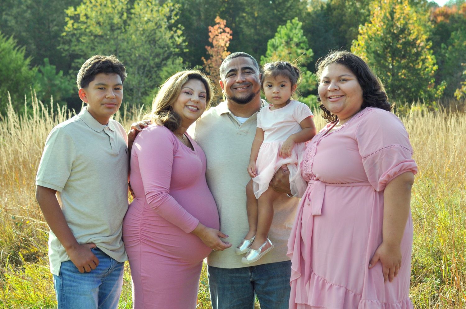 Family portrait with fall backdrop outdoors