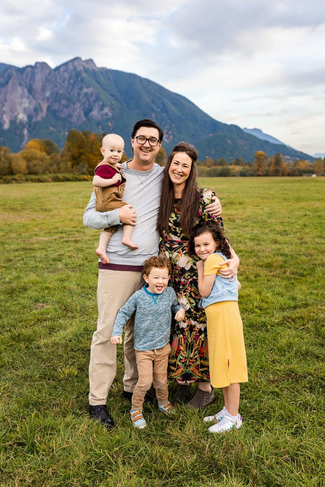 Bellevue photographer capturing fall family photos cuddling and smiling in North Bend.