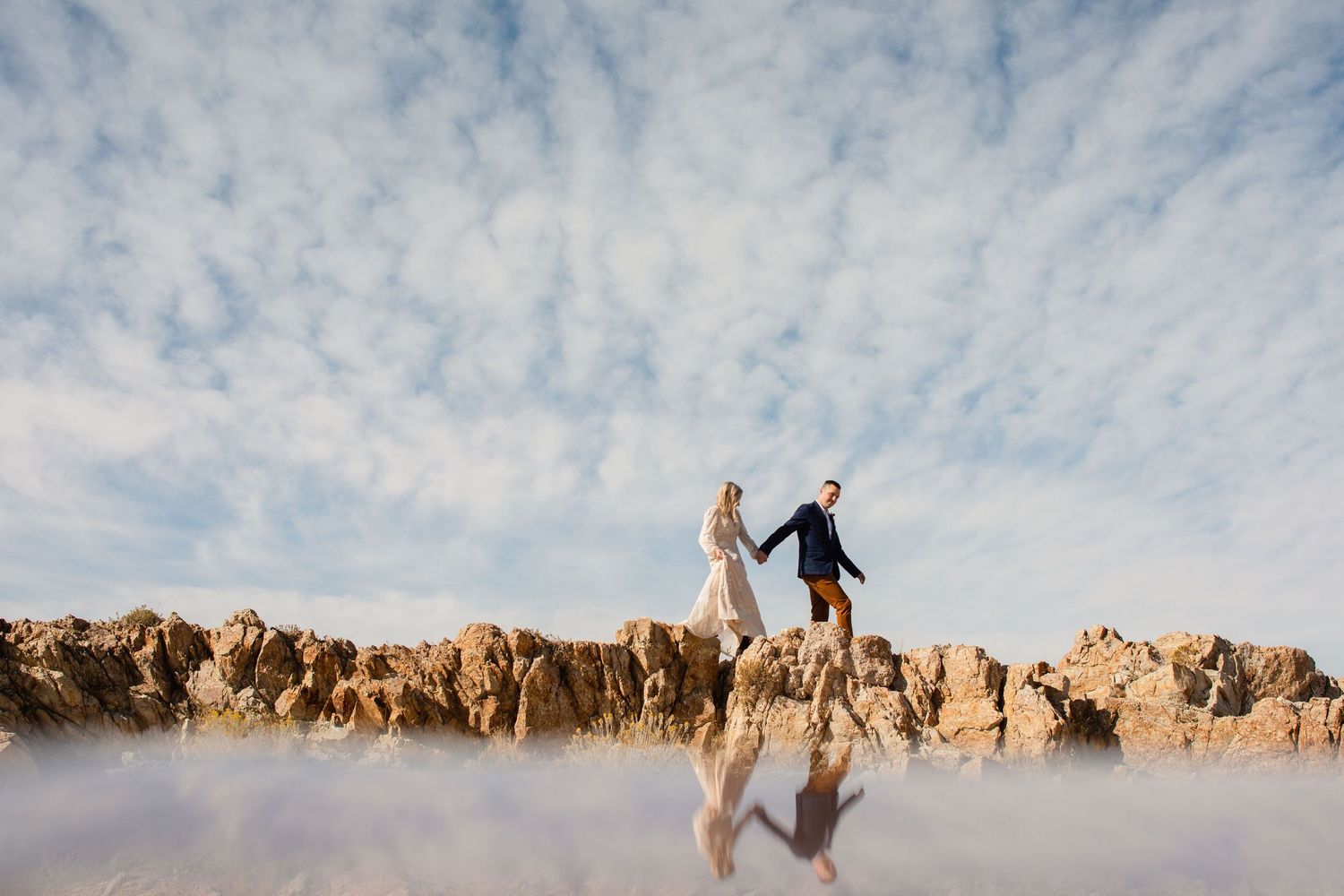 Couple on a cliff for their intimate adventure wedding.