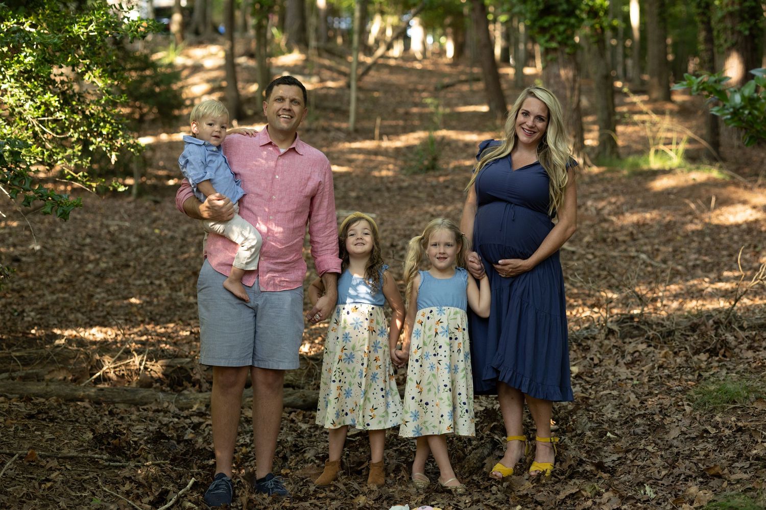 Family portrait in wooded setting with nature background.