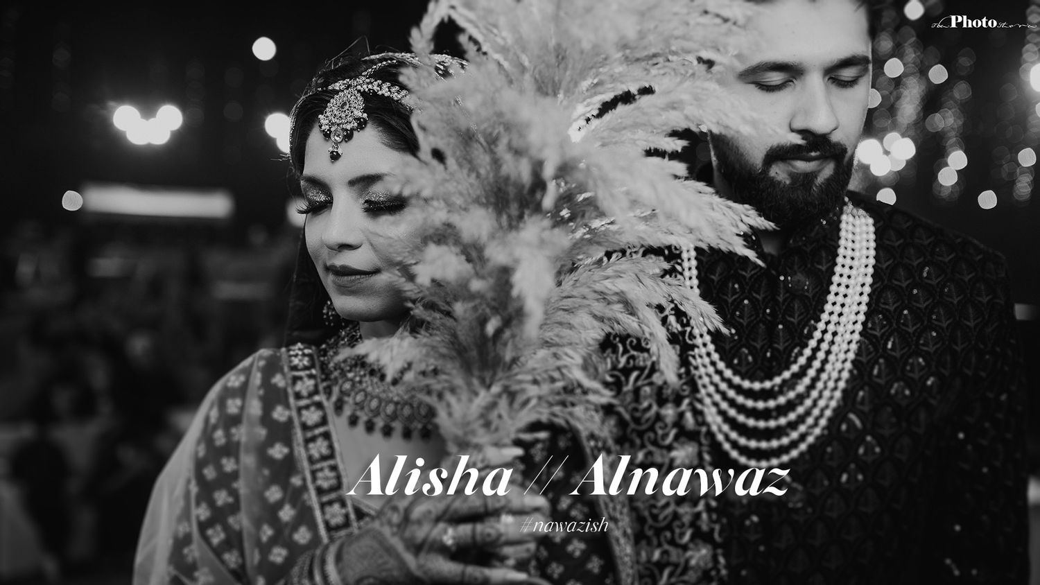 A stylized black and white wedding portrait with pearl necklaces and dramatic lighting.