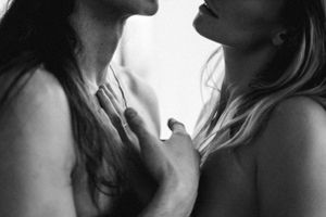 Intimate black and white portrait of two figures in close proximity.