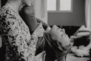Dramatic black and white indoor portrait capturing emotive moment.