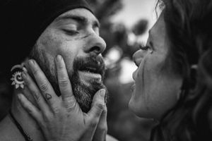 Intimate black and white close-up portrait of a tender romantic moment between two people.