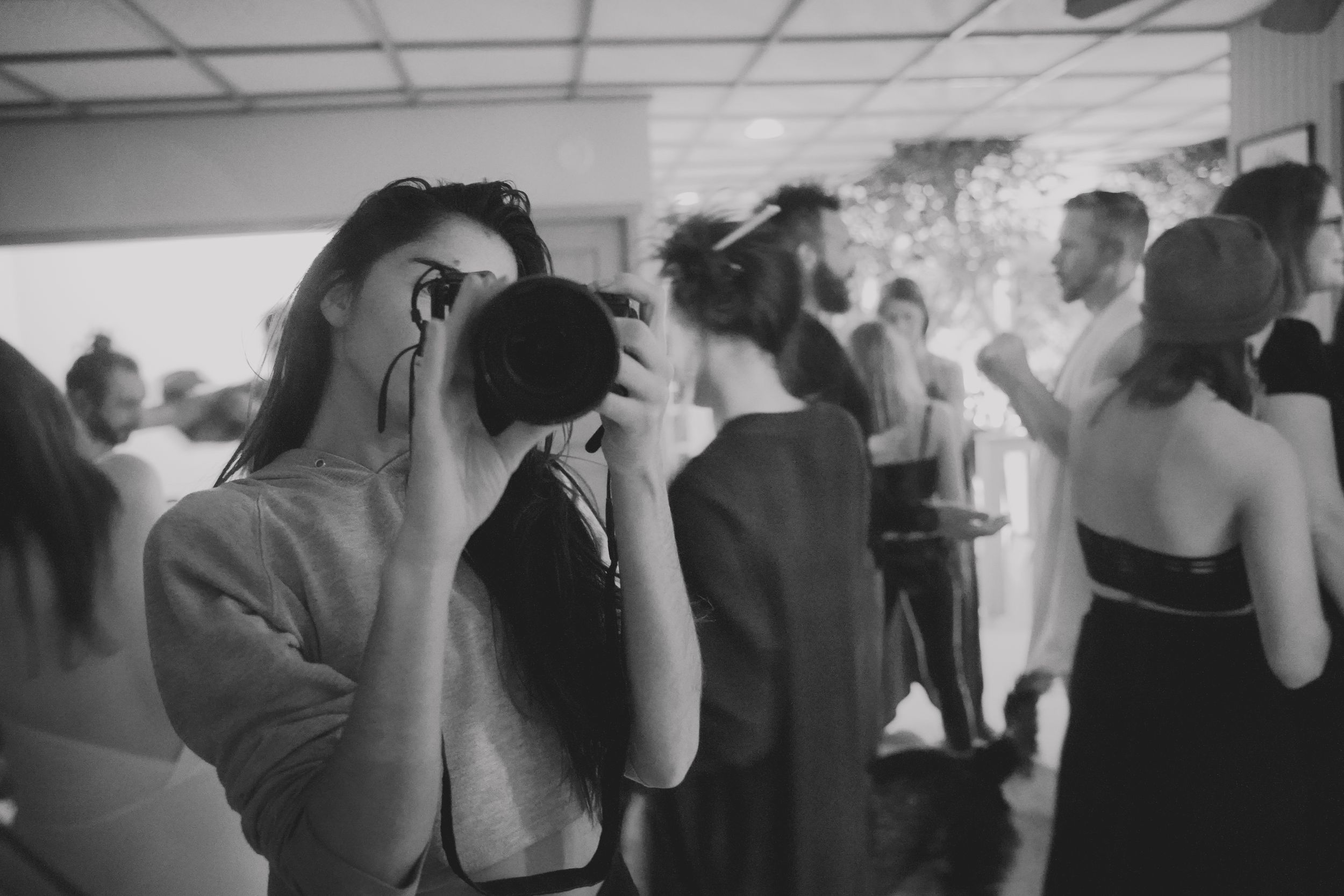 Black and white photo of a crowded dance floor with people in formal attire.