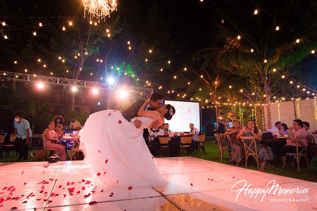 Outdoor evening reception with string lights and white decor creating a romantic ambiance.