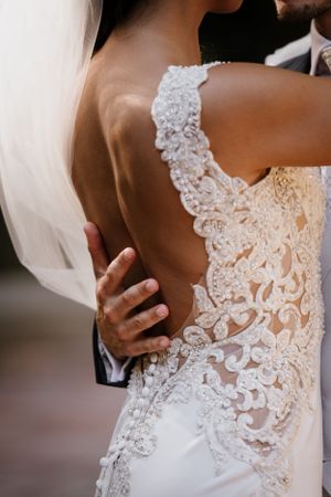 Close-up detail of intricate lace pattern on back of wedding dress. Getting marry in Verona