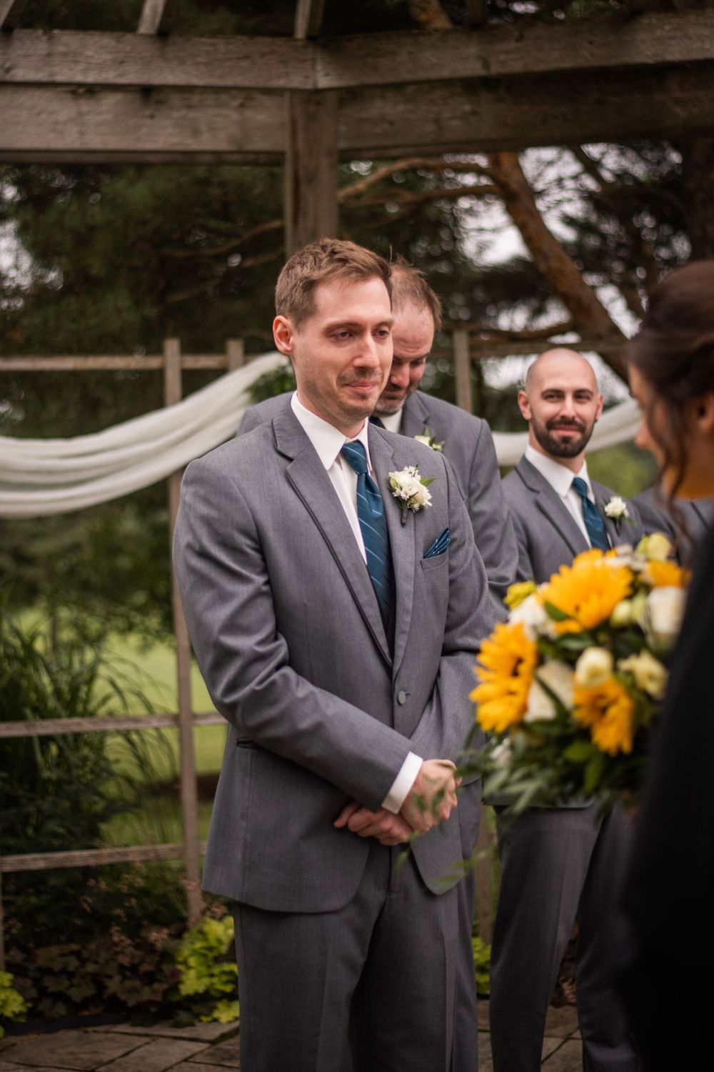 Grooms reaction to seeing bride walking down the aisle at Stratford Country Club wedding ceremony