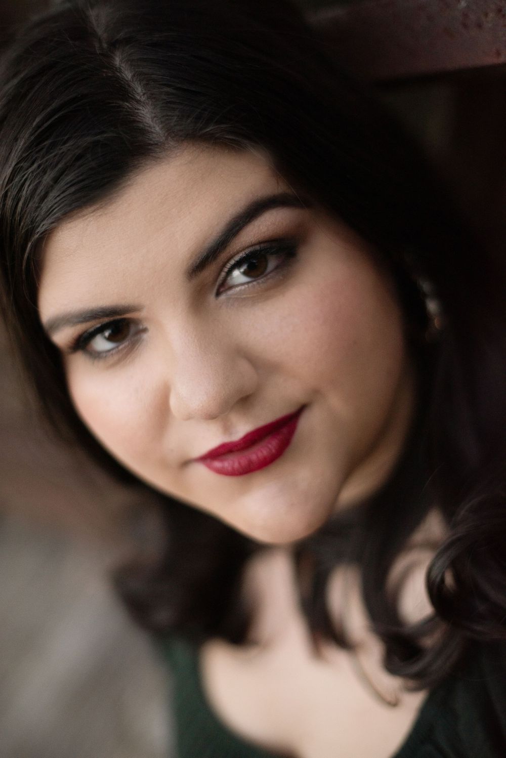 Close-up portrait with dramatic makeup and dark lipstick.