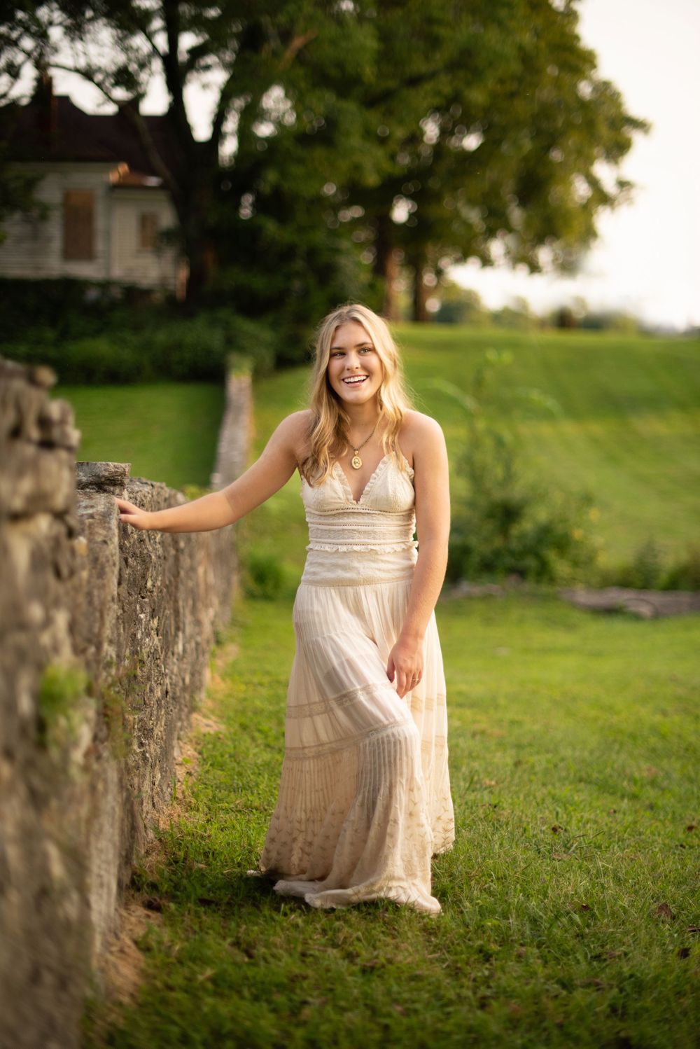 Franklin Senior Photographer at Harlinsdale farm in Free People dress and rock wall