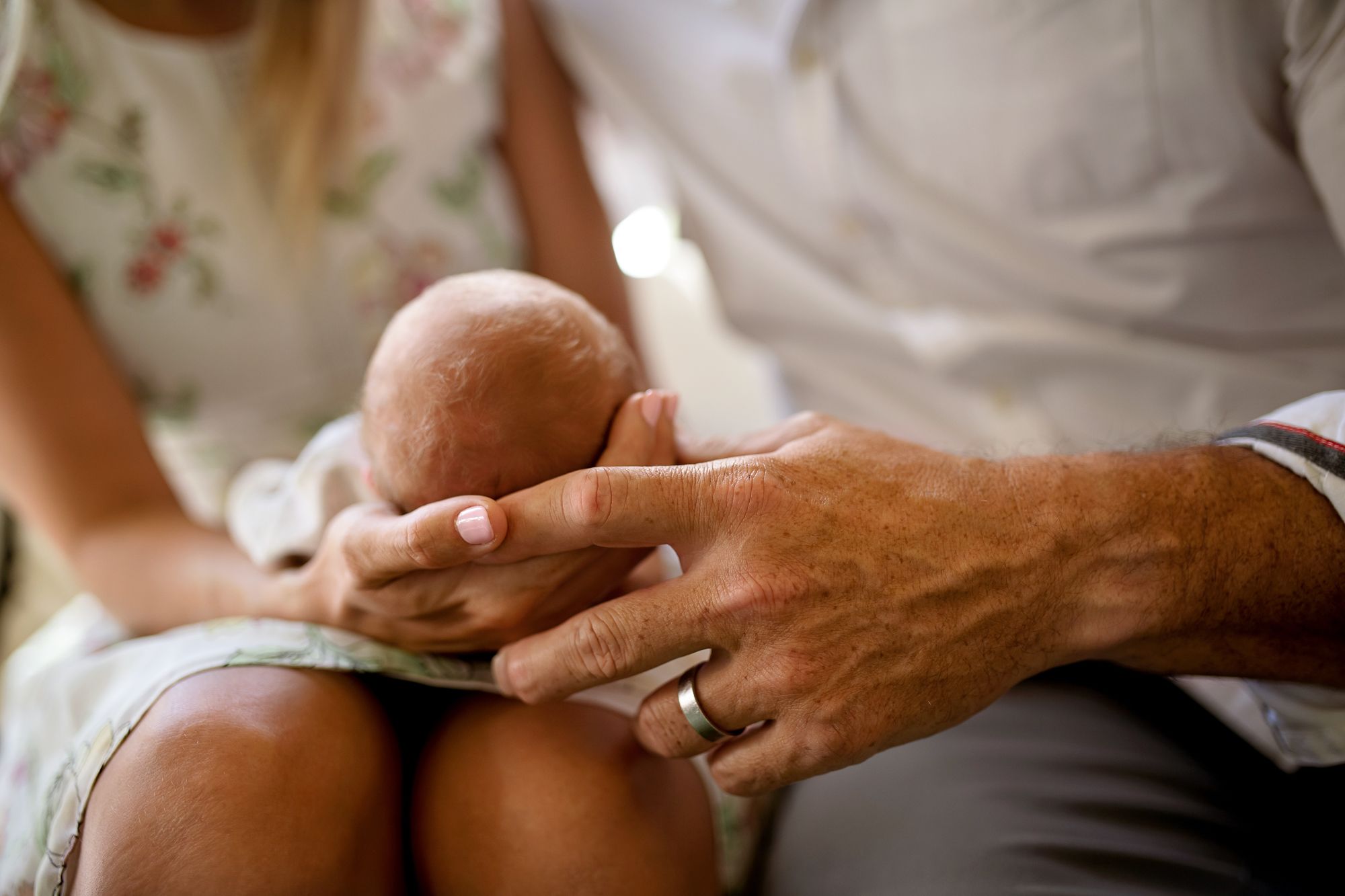 Parents holding baby Newborn Photoshoot