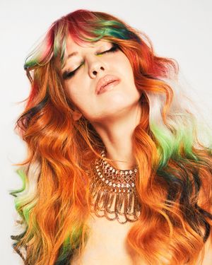 Long shag hairstyle. Multicoloured on copper hair