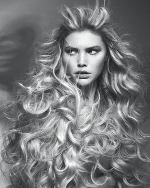 Big hair, curly, wavy. Blonde hair.