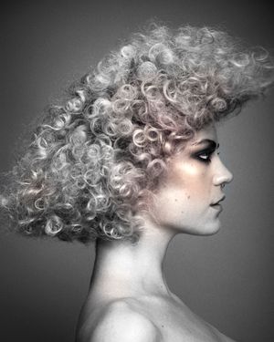 Curly textured hair, blonde and pastel pink.