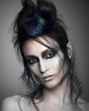 Loose up do on black hair with blue hair colour. Black and white hair photo.
