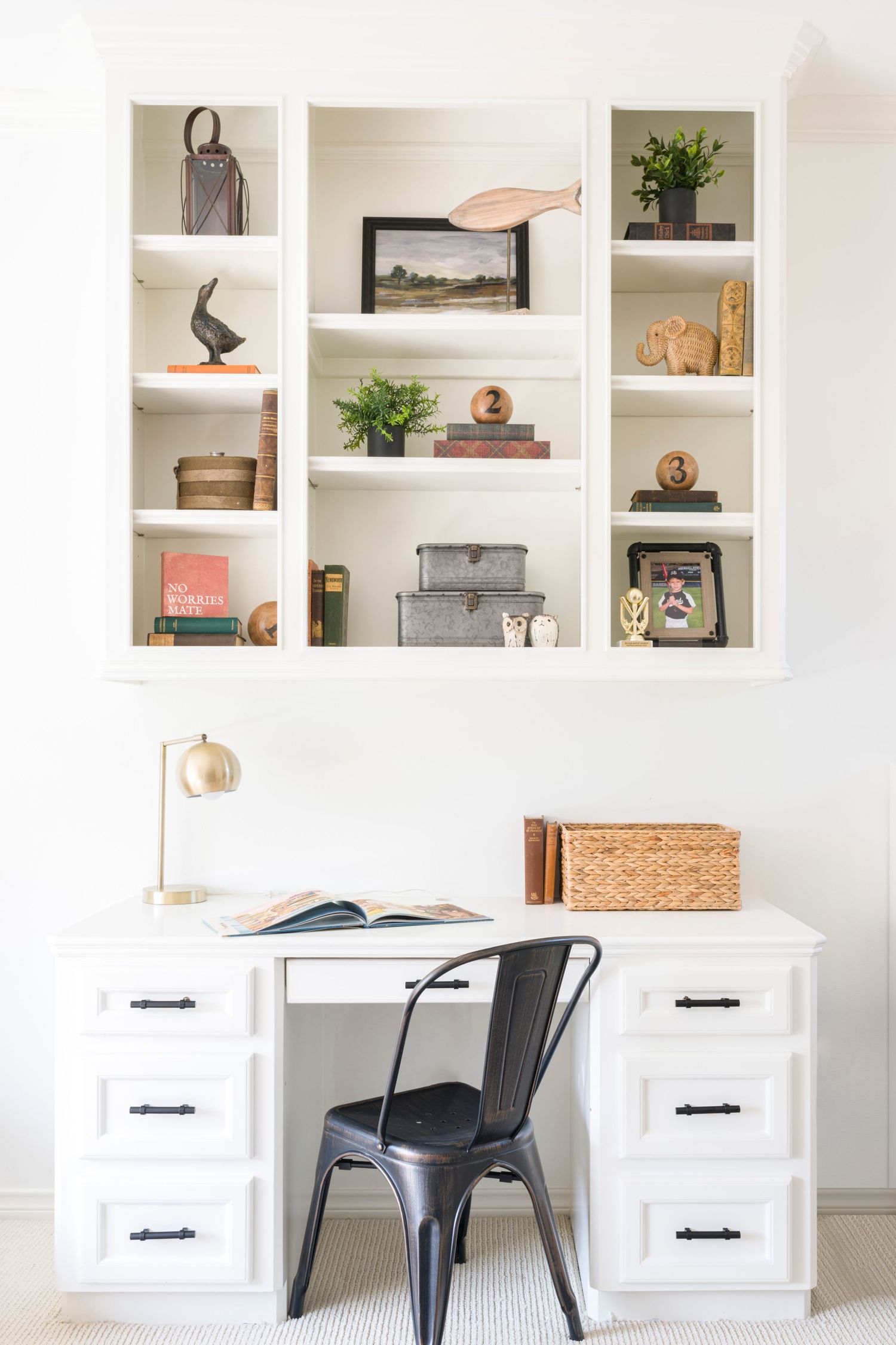 White built-in desk and shelving unit styled with decorative objects and plants. Interior Design, NJ Photo