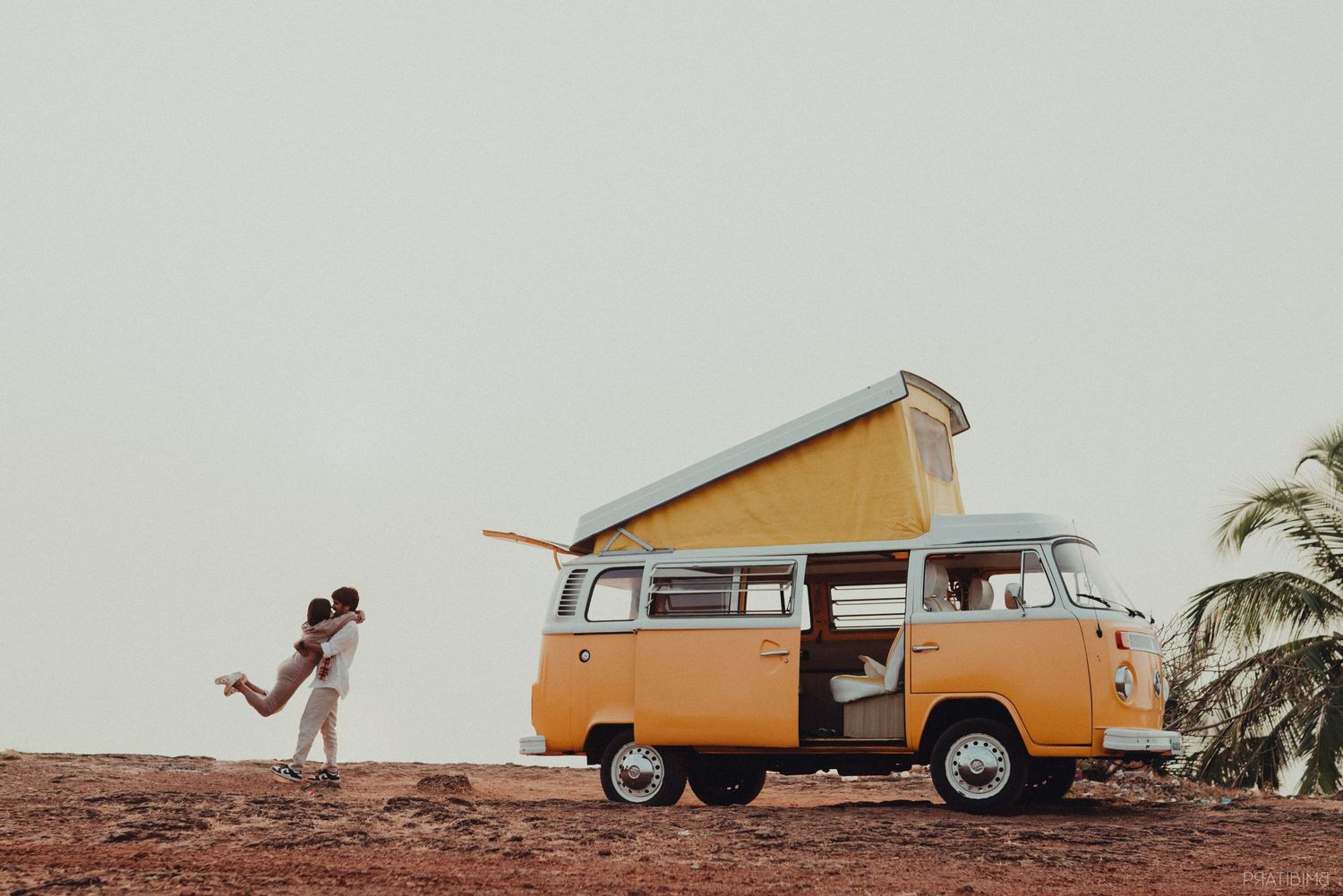 Vintage orange and white van photographed in sequence across a minimalist landscape.