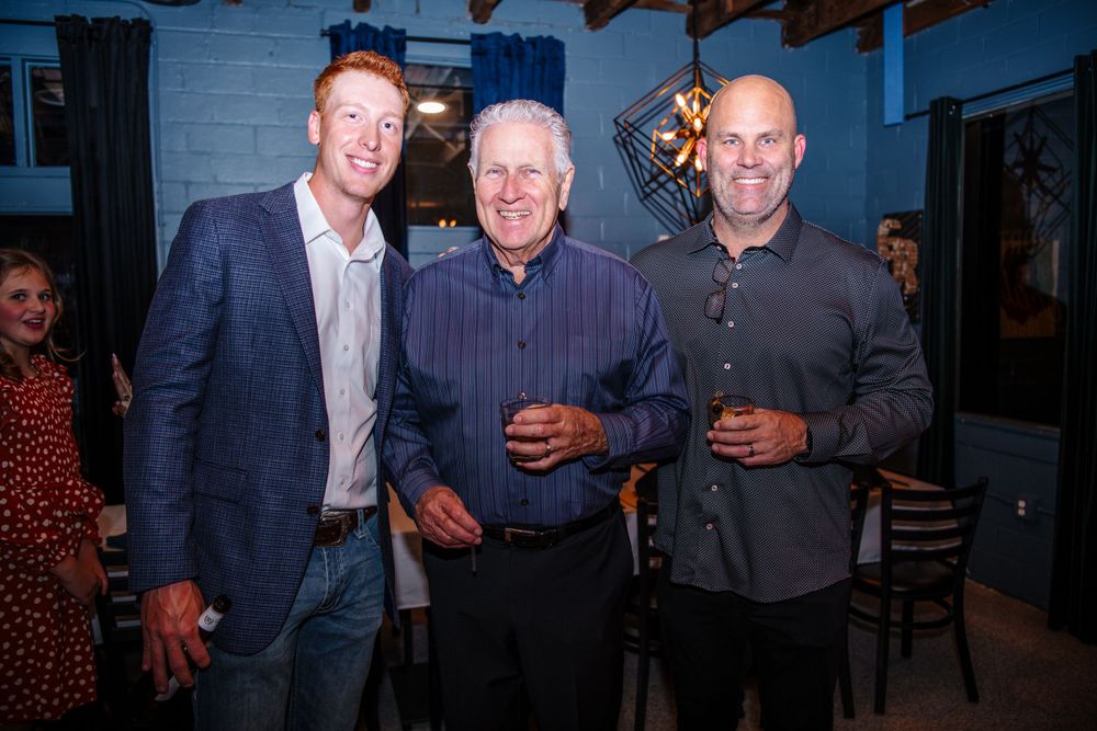 A group of guests socializing at an indoor evening event.