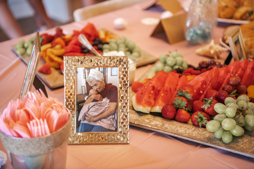 A party table spread with various appetizers, fruits, and snacks arranged on platters.