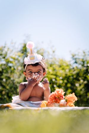A festive party scene outdoors with orange flowers and party decorations.