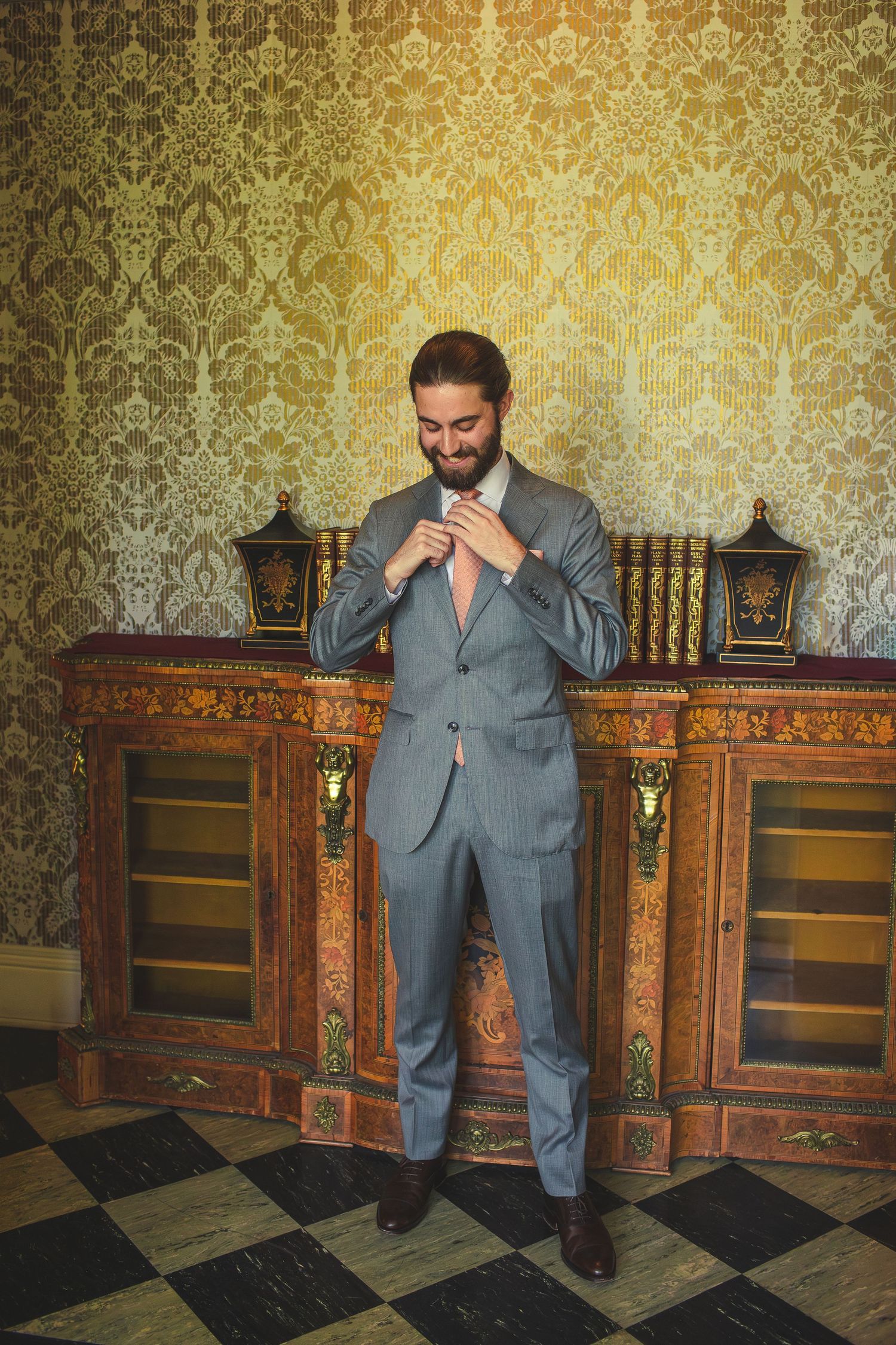 Groom getting ready inside Bower House at Tudor Place