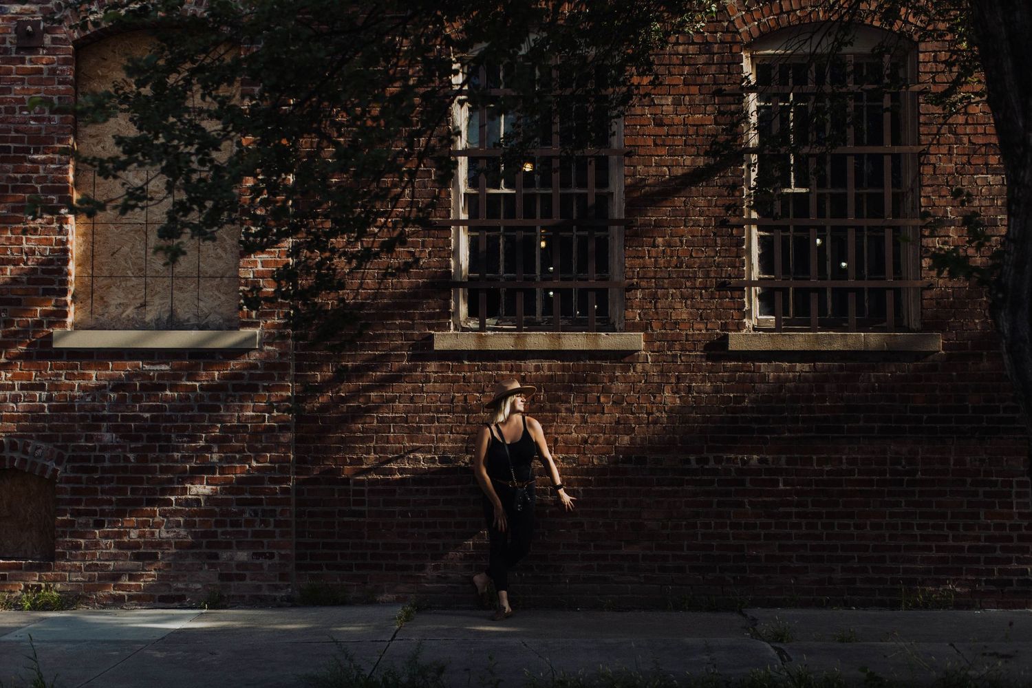 Architectural detail of a historic brick building with barred windows in natural lighting.