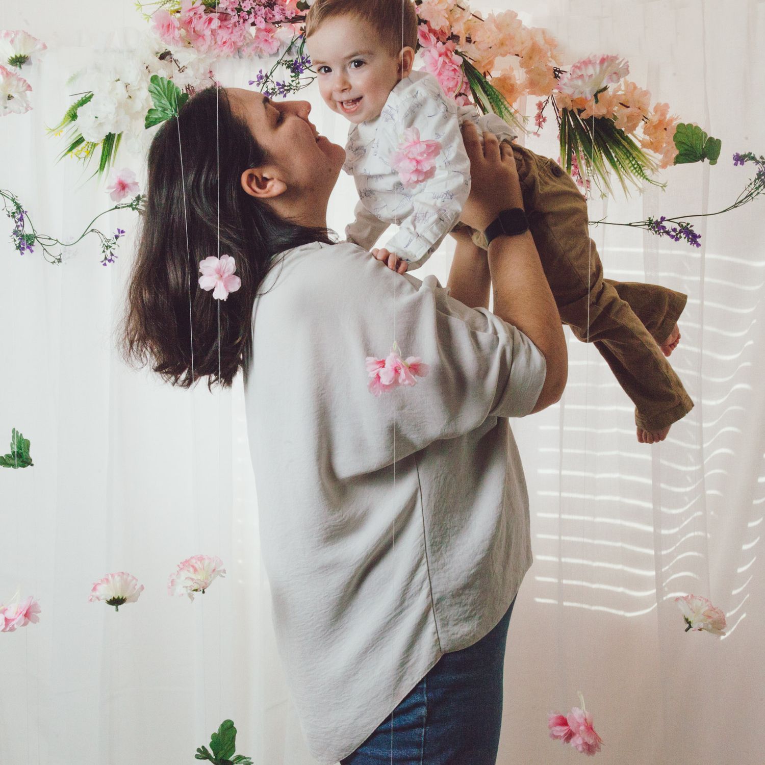 Mother lifting her son during a mini photoshoot, captured by Maria Photography, a family photographer in Gosport.