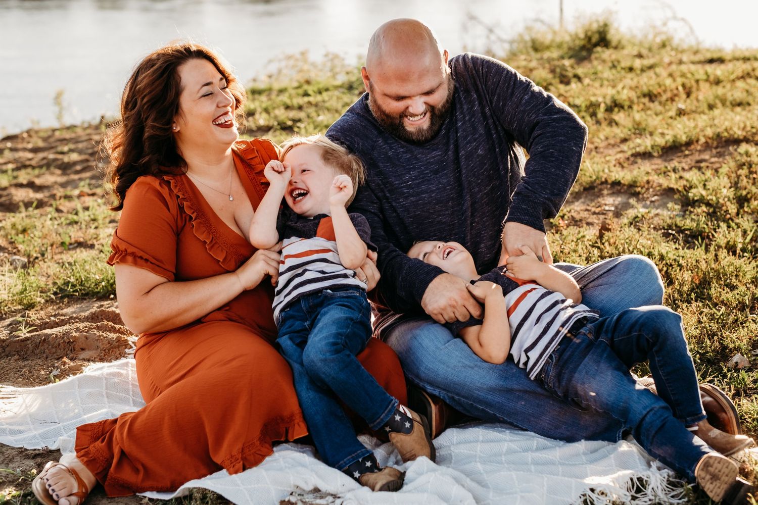 Family laughs together in a family photography portrait in Northwest Arkansas by Tiffany Arnold Photography.