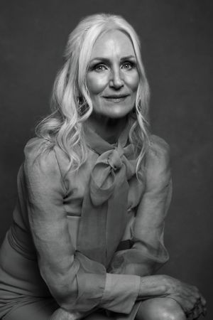 Black and white portrait series showing feminine poses in a structured blouse.