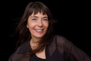 Natural portrait series with genuine smiles against dark background.