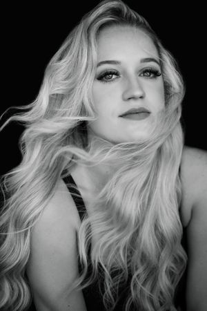 Black and white glamour portrait series showing blonde hair movement in dramatic lighting.