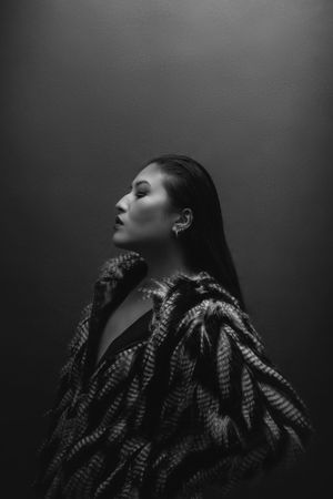 Dramatic silhouette series with textured hair pieces against dark background.