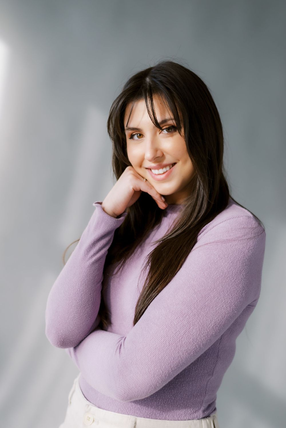 Casual portrait in lavender sweater with natural lighting.