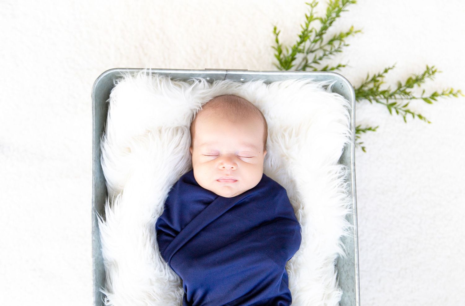 A precious newborn peacefully sleeping in a cozy swaddle, highlighting the serenity and vulnerability of early infancy.