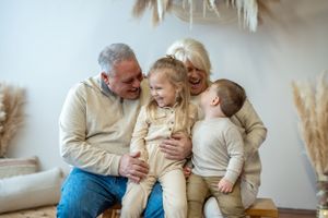 Candid family moment in cozy living room with pampas grass decor.