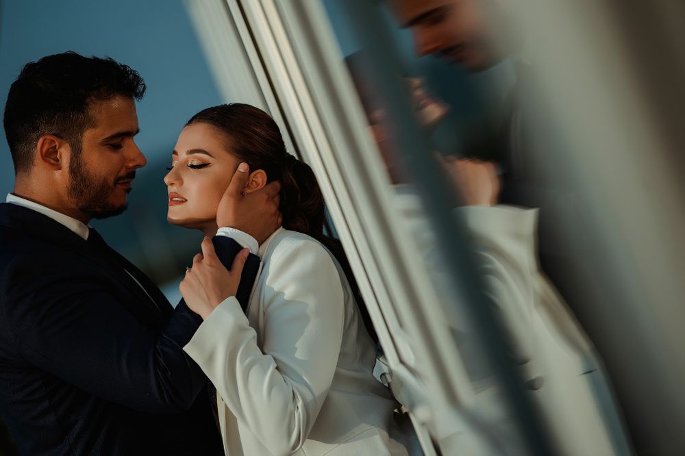 A romantic intimate portrait near a window with soft natural lighting.