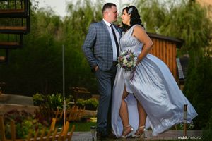 A romantic garden portrait featuring a flowing dress and spring greenery.