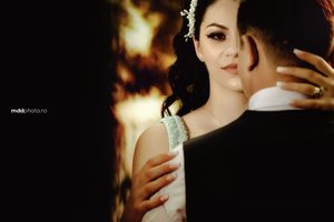 Intimate wedding portrait with soft focus and warm lighting creating dramatic atmosphere.
