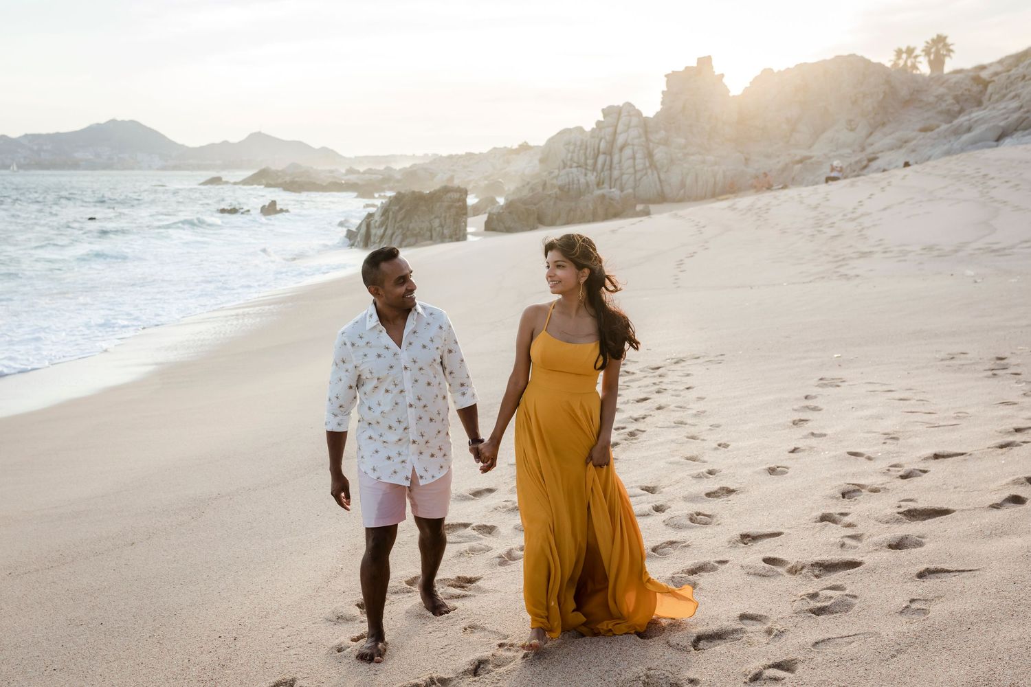 Couple enjoying romantic beach walk in Cabo San Lucas