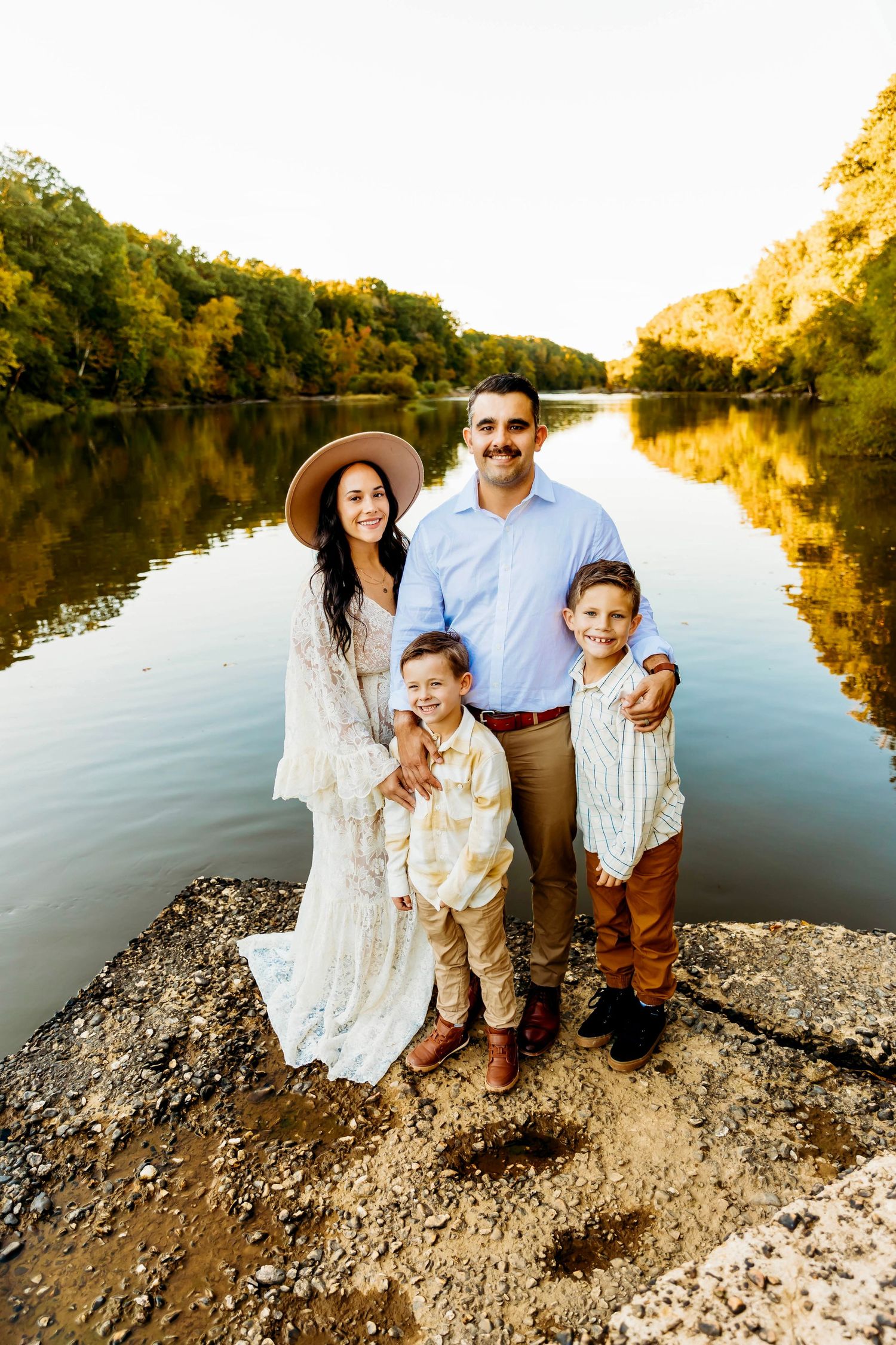 Beautiful Connecticut family in front of a sunset in a lake